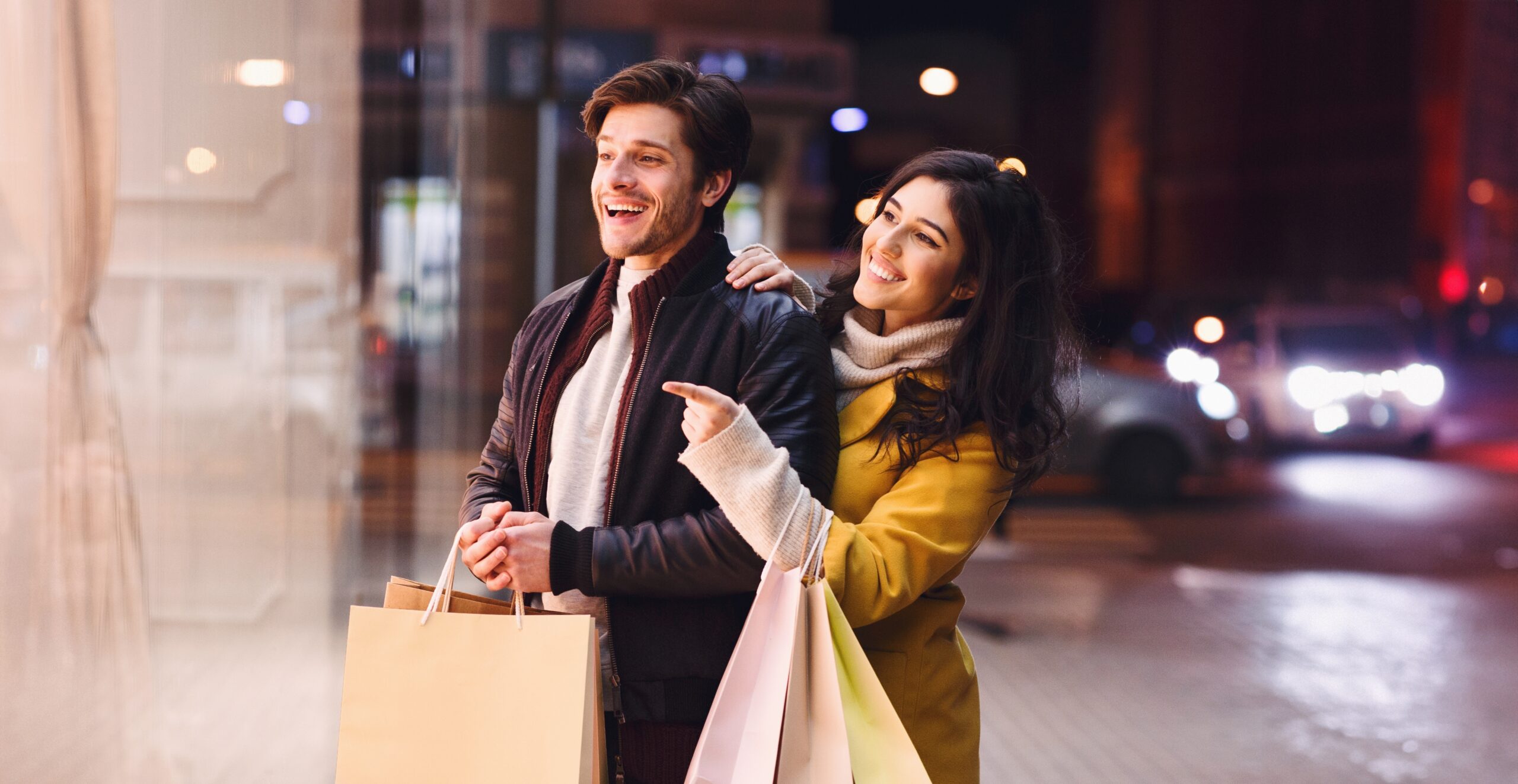 A couple looking at end-of-year sales promos